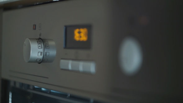 Person Turning Knob to Turn on Stove 3