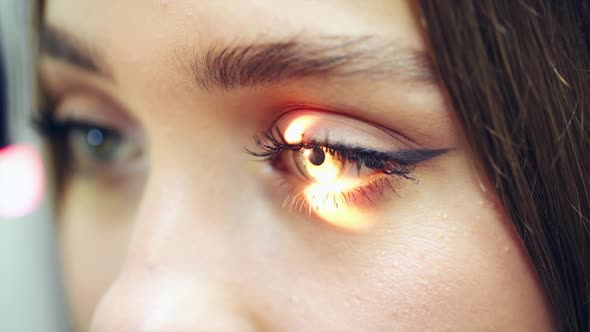 Young female checking her eyes at a doctor.