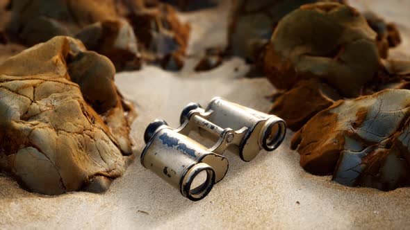 Old German Military Binoculars on the Sand Beach