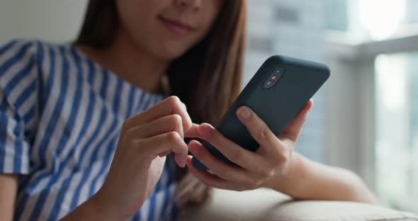 Woman use smart phone at home