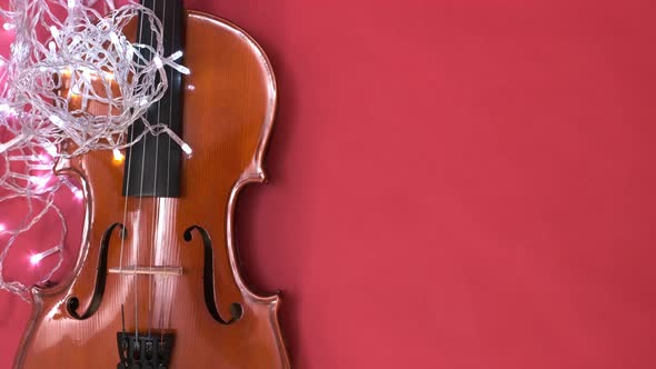 Classical Brown Violin on a Red Background with Copy Space A Musical Instrument with a Blinking