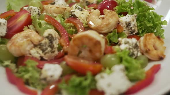 Plate Of Appetizing Salad With Shrimp Tomatoes Cheese And Lettuce