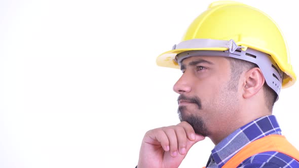 Closeup Profile View of Happy Bearded Persian Man Construction Worker Thinking