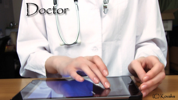 Doctor Working On Tablet Computer 