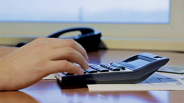 Financier Working on the Calculator