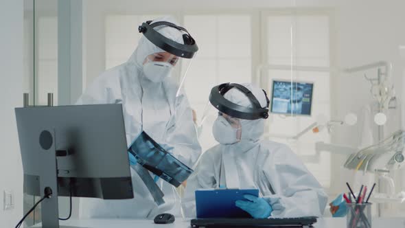 Professional Dentist and Assistant Examining x Ray of Teeth