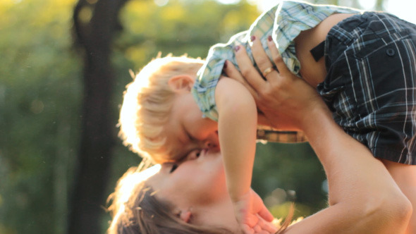 Family Mom Dad And Little Son Hugging In Nature