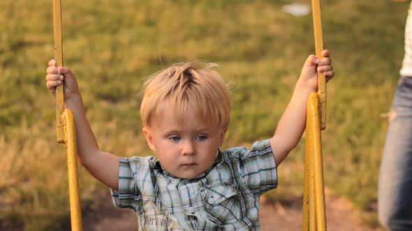 Parents Ride On A swing Of His Son