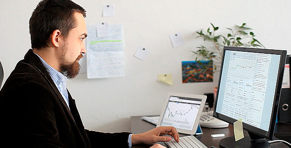 Businessman Exploring Currency Exchange Charts