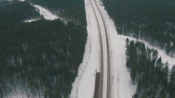 Flying Above Winter Forest and Railroad