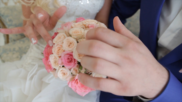 Wedding Bouquet in Hands of The Bride and Groom