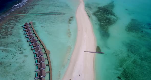 Tropical aerial island view of a white sand paradise beach and aqua blue ocean background 