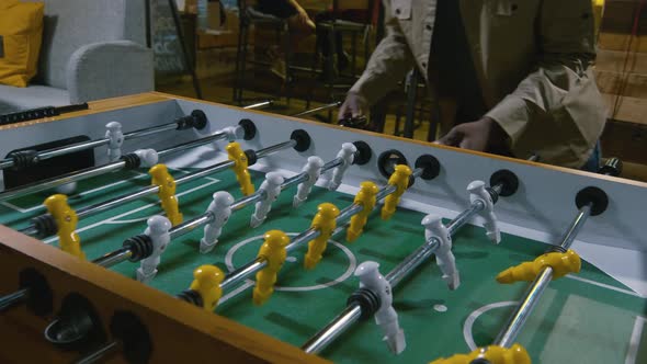 Two men playing table football