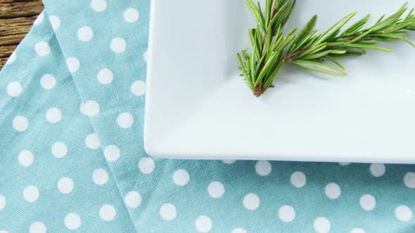 Green olives and rosemary herbs on table