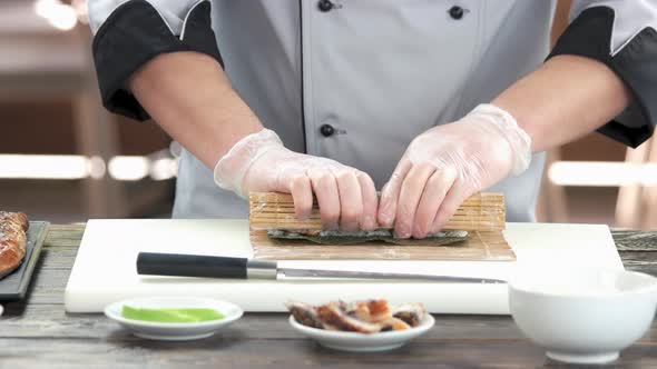 Chef Making a Sushi Roll.