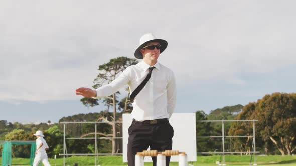 Cricket umpire making signs standing on a cricket pitch