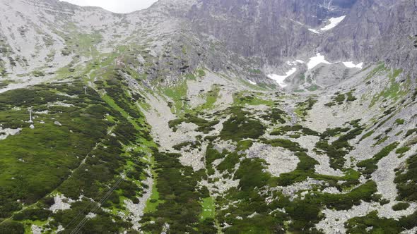 AERIAL: Reveal Shot of a Valley with a blue lake near the Mountain in Slovakia