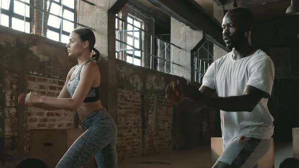 Fitness. Couple doing leg lunge exercise workout at sport gym