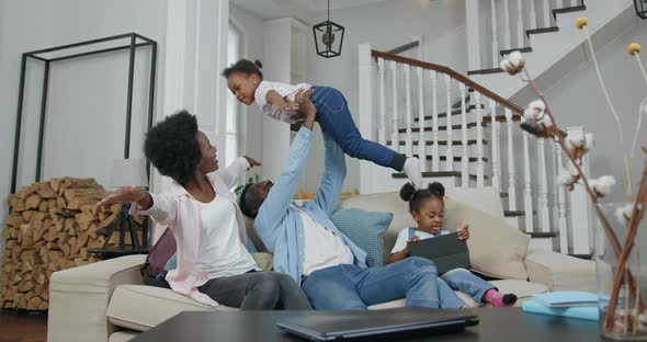 African American Family Having Fun Together while Spending their Leisure at Home
