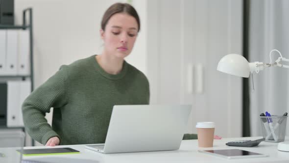 Young Woman Coming Back Working on Laptop 