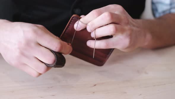 The Tanner Is Stitching a Hand-made Leather Wallet