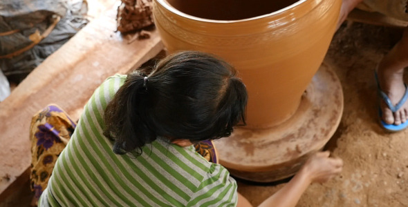 Woman Rotating Pottery Wheel