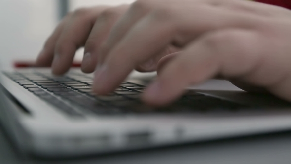 Man Is Typing On Laptop Keyboard