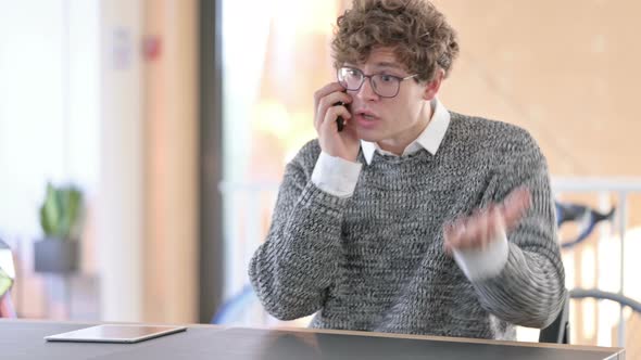 Angry Young Man Talking on Smartphone