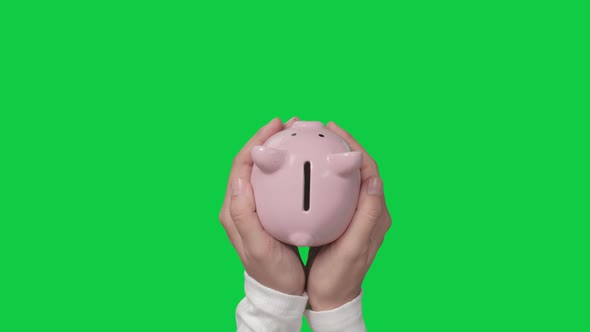 Saving money concept, Woman hand hold a piggy ban