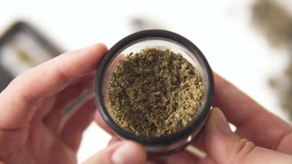 grinder to grind marijuana weed against a background of flowers 