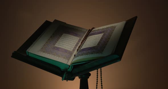 Holy Quran On Book Rest With Prayer Beads