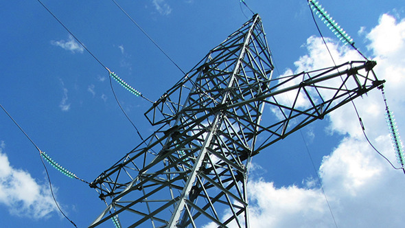 Tall Electric Masts Against Cloudy Sky alt