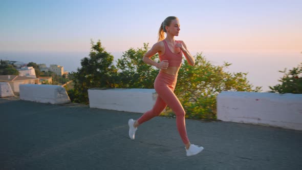 Strong Athletic Young Woman Run on Sunrise in City