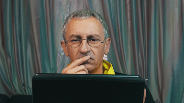 Portrait Dissatisfied Man Reading a Tablet