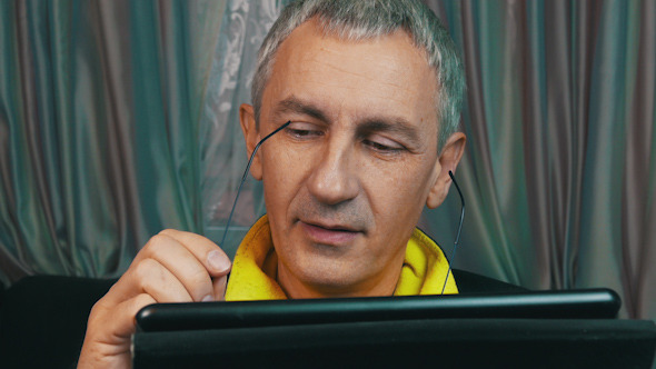 Portrait Smiling Man Reading a Tablet