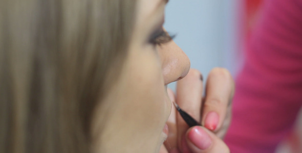 Makeup Artist Apply Makeup to the Lips