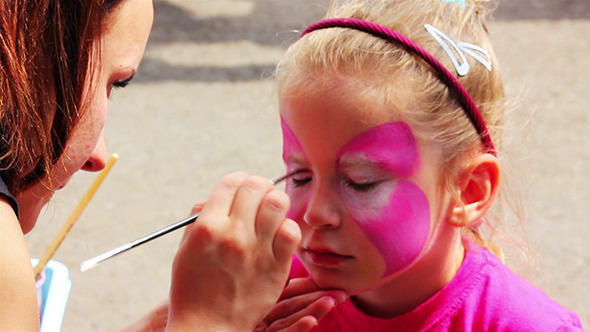 Artist Paints On Face Of Little Girl