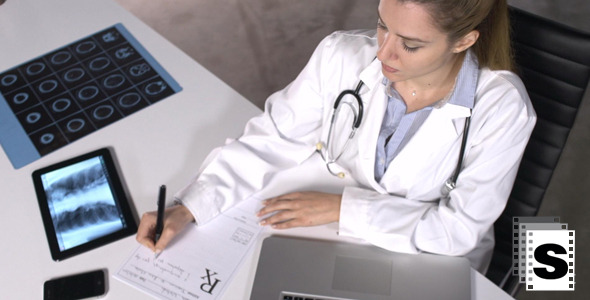 Female Doctor Writing Prescription