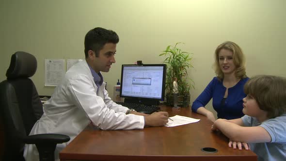 Male Doctor Consults With Mother And Son (6 Of 6)