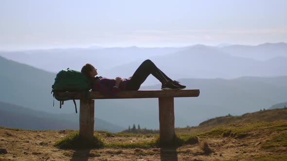 Female Hiker Resting on Top of the Mountain