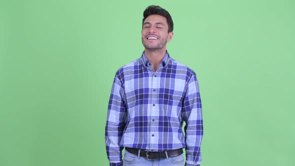 Happy Young Hispanic Man Relaxing with Eyes Closed