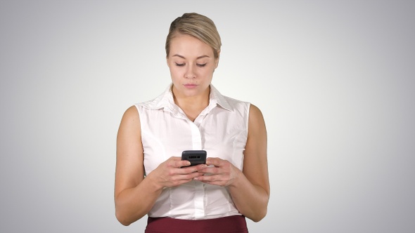 Portrait of blond mature woman using mobile phone Smiling