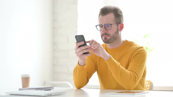 Upset Man Reacting to Loss on Smartphone