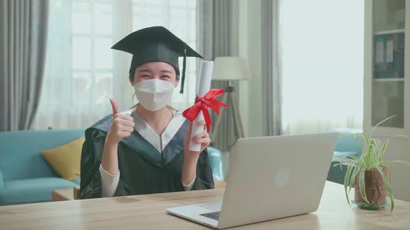 Woman Wearing Protection Face Mask, Thumb Up And Showing Off A University Certificate To Camera