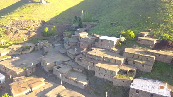 Flight over the rural with birds, A village on a green hill.