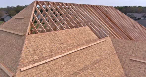 Roofer Working on a New Roof in Wood