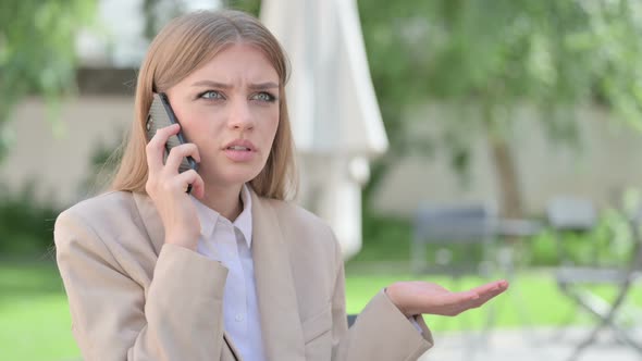 Outdoor Angry Young Businesswoman Talking on Phone
