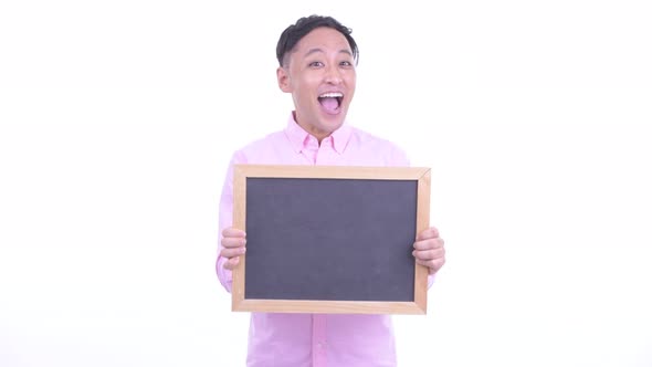 Happy Japanese Businessman Holding Blackboard and Getting Good News