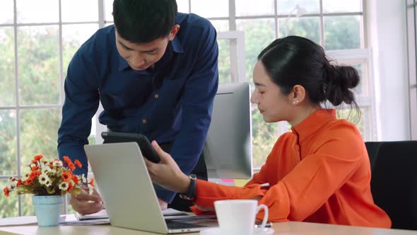 Two Business People Talk Project Strategy at Office