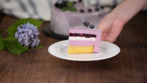 Piece of Layered Berry Mousse Cake With Mirror Glaze.